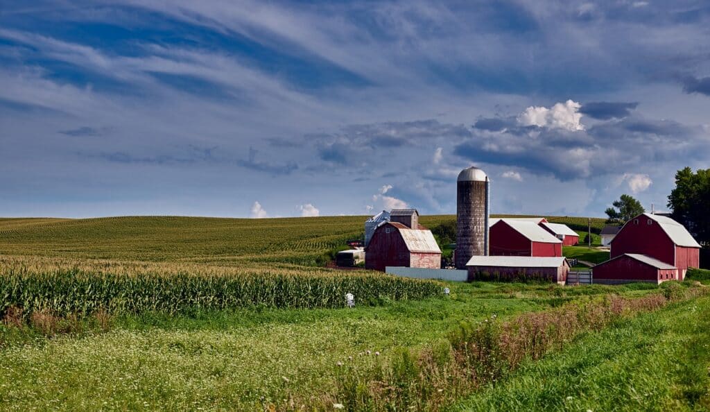It's not all about Iowa politics. Here is a tall silo and rural farmyard under a blue, cloudy sky. Photo:: Pixaby